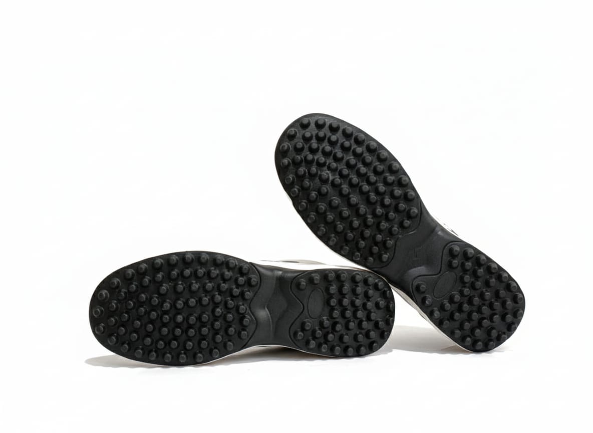 White sneakers with blue accents, tread pattern on sole